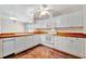 Bright kitchen features white appliances, white cabinetry and hardwood flooring at 2407 Waterford Ct, Palmetto, FL 34221