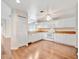 Bright kitchen features white appliances, white cabinetry, hardwood flooring and a built-in pantry at 2407 Waterford Ct, Palmetto, FL 34221