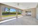 Enclosed lanai with white ceiling fans and expansive screened windows showcasing backyard at 2407 Waterford Ct, Palmetto, FL 34221