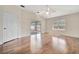 A spacious living room features hardwood floors, a ceiling fan, and a patio at 2407 Waterford Ct, Palmetto, FL 34221