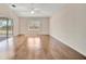 A spacious living room features hardwood floors, a ceiling fan, and a window at 2407 Waterford Ct, Palmetto, FL 34221