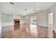 Bright living room boasts a fireplace, built-in shelves, hardwood flooring and ceiling fans at 2407 Waterford Ct, Palmetto, FL 34221
