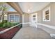 Screened porch with ceiling fan, tile flooring, and views of landscaped backyard at 2407 Waterford Ct, Palmetto, FL 34221