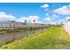 Lush backyard with a waterway and distant palm trees at 2408 28Th E Ave, Palmetto, FL 34221