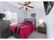 Bedroom with a ceiling fan, large window, and stylish, colorful bedding at 2408 28Th E Ave, Palmetto, FL 34221
