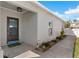 Inviting entryway featuring a tiled floor, dark front door, and well-kept landscaping at 2408 28Th E Ave, Palmetto, FL 34221