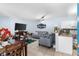 Open-concept living area with comfortable seating, a modern TV, and adjacent kitchen at 2408 28Th E Ave, Palmetto, FL 34221