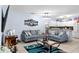 Bright and open living room featuring modern decor, tile flooring, and a connected kitchen area at 2408 28Th E Ave, Palmetto, FL 34221