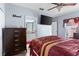 Relaxing bedroom with a dresser, TV, and view into an ensuite bathroom at 2408 28Th E Ave, Palmetto, FL 34221