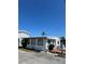 Charming single-story home featuring a well-maintained exterior and cozy front porch at 2601 Gulf N Dr # 214, Bradenton Beach, FL 34217