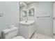Bathroom featuring toilet, vanity with modern faucet, mirrored wall cabinets, and tile flooring at 2625 Terra Ceia Bay Blvd # 506, Palmetto, FL 34221
