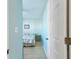 Bedroom featuring door, picture frame, light blue paint, and bed with a bedside table in the background at 2625 Terra Ceia Bay Blvd # 506, Palmetto, FL 34221