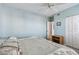 Bedroom featuring ceiling fan, picture frame, light blue paint, queen-sized bed, and double door closet at 2625 Terra Ceia Bay Blvd # 506, Palmetto, FL 34221