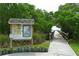 Picturesque view of a waterfront boardwalk leading to a pier, surrounded by lush greenery at 2625 Terra Ceia Bay Blvd # 506, Palmetto, FL 34221
