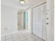 Bright and spacious hallway with white tile flooring and multiple closets and doors at 2625 Terra Ceia Bay Blvd # 506, Palmetto, FL 34221