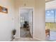 Hallway leads into a bedroom with wood floor and water view balcony at 2625 Terra Ceia Bay Blvd # 506, Palmetto, FL 34221