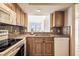 Functional kitchen with wood cabinets and a window view to the living area at 2625 Terra Ceia Bay Blvd # 506, Palmetto, FL 34221
