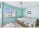 Bright bedroom featuring ceiling fan, shuttered window, and queen-sized bed at 2625 Terra Ceia Bay Blvd # 506, Palmetto, FL 34221