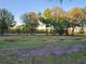 Spacious backyard with mature trees and a split rail fence at 28120 63Rd E Ave, Myakka City, FL 34251