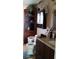 Functional bathroom with dark wood cabinets and a tiled floor, featuring a corner shelf and sink at 28120 63Rd E Ave, Myakka City, FL 34251