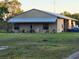 Charming single-Gathering home boasting a metal roof, covered porch, mature landscaping, and ample parking space at 28120 63Rd E Ave, Myakka City, FL 34251