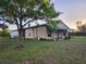 Charming single-Gathering home with a barn, surrounded by a lush green lawn and mature trees at 28120 63Rd E Ave, Myakka City, FL 34251