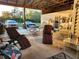 Large covered patio with outdoor furniture, perfect for relaxation and entertaining with ample parking space nearby at 28120 63Rd E Ave, Myakka City, FL 34251