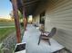 Inviting porch with comfortable seating, providing a relaxing outdoor space with views of the surrounding landscape at 28120 63Rd E Ave, Myakka City, FL 34251