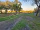 Expansive grassy property with mature trees and wooden fencing at 28120 63Rd E Ave, Myakka City, FL 34251