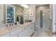 Modern bathroom with double sinks, white cabinets, and a glass-enclosed shower, creating a spa-like retreat at 3169 Alba Cir, Bradenton, FL 34211