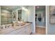 Bright bathroom with double sinks, granite countertops, ample storage, and a walk-in shower with closet at 3169 Alba Cir, Bradenton, FL 34211