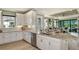 Spacious kitchen with a granite island and stainless appliances flows into an open-concept living area at 3169 Alba Cir, Bradenton, FL 34211