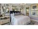 Luxurious main bedroom features stylish lighting, three wall mirrors, and elegant decor at 3169 Alba Cir, Bradenton, FL 34211