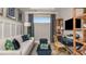 Comfortable home office includes a white sofa, work desk, shelving and natural light at 3169 Alba Cir, Bradenton, FL 34211
