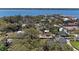 An aerial view shows a neighborhood and community nestled in a wooded area with a bay in the distance at 3304 7Th Street W Ct, Palmetto, FL 34221