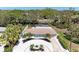 An aerial view displays the property, pool, and attractive landscaping against a backdrop of mature trees at 3304 7Th Street W Ct, Palmetto, FL 34221