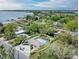 This is an aerial view of the property showcasing the surrounding landscape with an in-ground pool and circular driveway at 3304 7Th Street W Ct, Palmetto, FL 34221