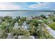 Beautiful aerial shot showcasing a home with a pool, set against a backdrop of lush greenery and waterfront views at 3304 7Th Street W Ct, Palmetto, FL 34221