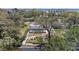 Aerial view of the backyard with a screened in pool, lush landscape and a unique stone path to the fire pit area at 3304 7Th Street W Ct, Palmetto, FL 34221