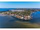 An aerial view shows a waterfront community with luxury homes, boat docks, marinas, and beautiful landscaping at 3304 7Th Street W Ct, Palmetto, FL 34221