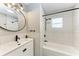 Modern bathroom featuring a shower and tub combo, sleek vanity, and round mirror at 3304 7Th Street W Ct, Palmetto, FL 34221