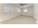 Bright bedroom featuring a ceiling fan, plantation shutters, and neutral walls at 3304 7Th Street W Ct, Palmetto, FL 34221