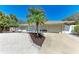Exterior view showcasing a well-maintained property with a two-car garage and a lovely turquoise door at 3304 7Th Street W Ct, Palmetto, FL 34221