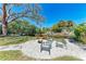 This backyard has a stone fire pit area surrounded by chairs perfect for gathering, relaxing and enjoying the outdoors at 3304 7Th Street W Ct, Palmetto, FL 34221