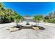 Charming home featuring an artful circular driveway with palm trees and bright, stylish curb appeal at 3304 7Th Street W Ct, Palmetto, FL 34221