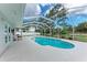 Screened-in pool area featuring an in-ground pool, deck, and outdoor dining space at 3304 7Th Street W Ct, Palmetto, FL 34221