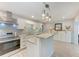 Modern kitchen featuring white cabinets, stainless steel appliances, and a stylish backsplash at 3507 24Th W Ave, Bradenton, FL 34205