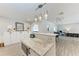 Open concept kitchen island, with stainless appliance, marble counter and adjacent living space at 3507 24Th W Ave, Bradenton, FL 34205