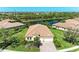 Beautiful home aerial view overlooking lush landscaping, a serene pond, and other similar properties at 428 Grand Preserve Cv, Bradenton, FL 34212