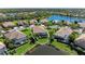 Aerial real estate view of a home with screened lanai, pond, and lush landscaping at 428 Grand Preserve Cv, Bradenton, FL 34212
